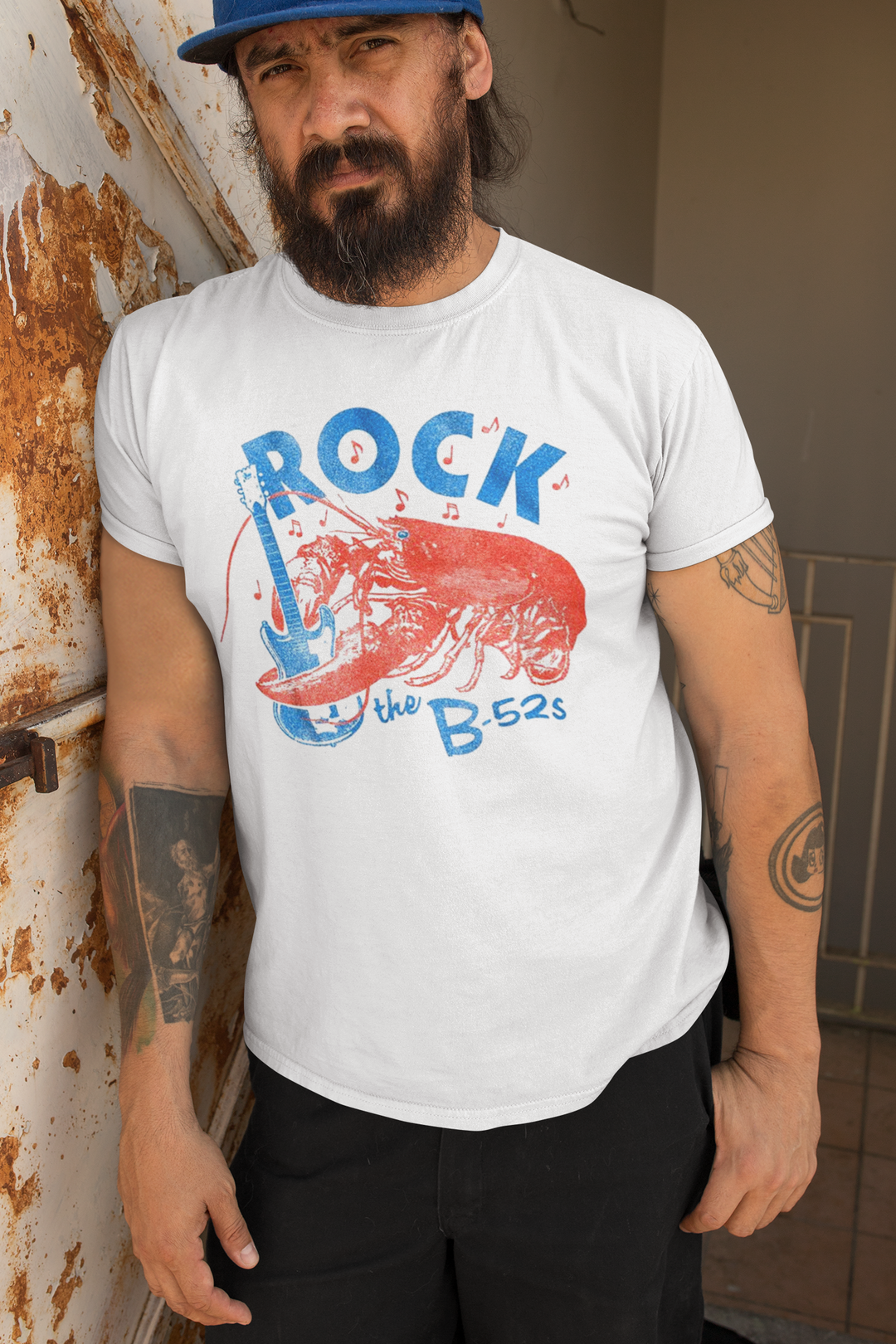 **IMPORTED FROM THE U.S.A - We have very limited stock of this t-shirt, and once it is sold out we are unable to get new stock as it has been discontinued**
Known for their unique sound and energetic performances, The B-52's have been incredibly influential to a whole host of bands. Their style is instantly recognizable. With hits like "Love Shack" and "Rock Lobster," they have gained a dedicated fan base worldwide. Their catchy melodies and quirky lyrics make them a standout act in the New Wave genre.
