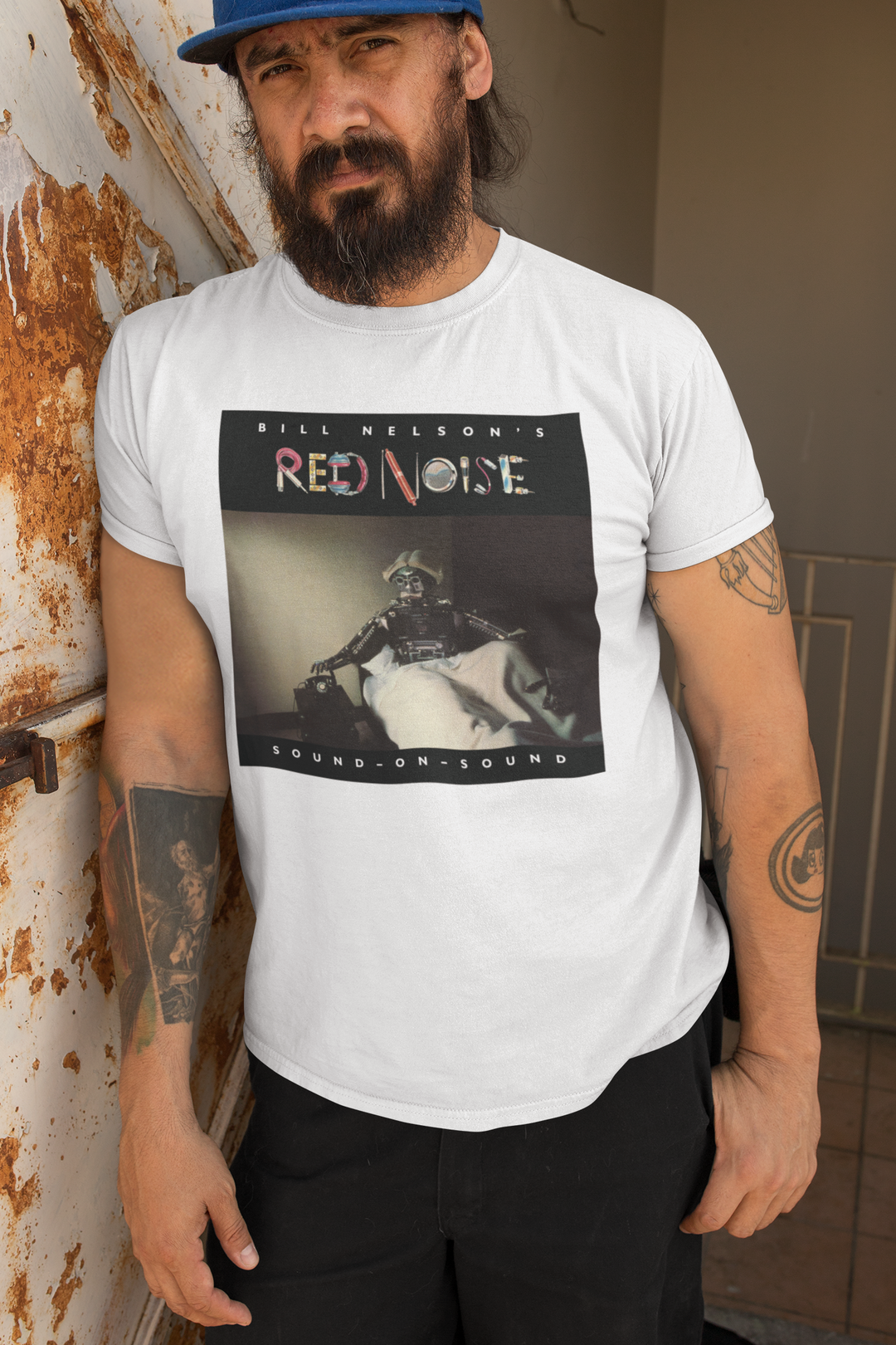 Bill Nelson's Red Noise Sound on Sound T-shirt  - Following the release of the album ‘Drastic Plastic’ ,Bill Nelson disbanded Be Bop Deluxe. Aware of the emergence of the so-called New Wave artists and out of a desire to continually evolve and progress as a musician, he announced the formation of a new band, Red Noise. 
Working with co-producer John Leckie, Bill recorded a new wave masterpiece, a record that would influence a new generation of musicians with its intelligent and punchy material.