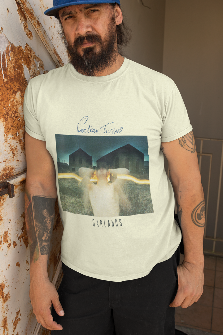 Cocteau Twins - Garlands T-Shirt 
Cocteau Twins were a Scottish post-punk/ethereal/dream pop band formed in 1981 in Grangemouth, Falkirk. Known for their unique sound and ethereal vocals, the band captivated audiences with their dreamlike melodies and atmospheric music. With a career spanning over 15 years, Cocteau Twins left an indelible mark on the music industry before disbanding in 1997. Their innovative approach to music continues to inspire artists today.