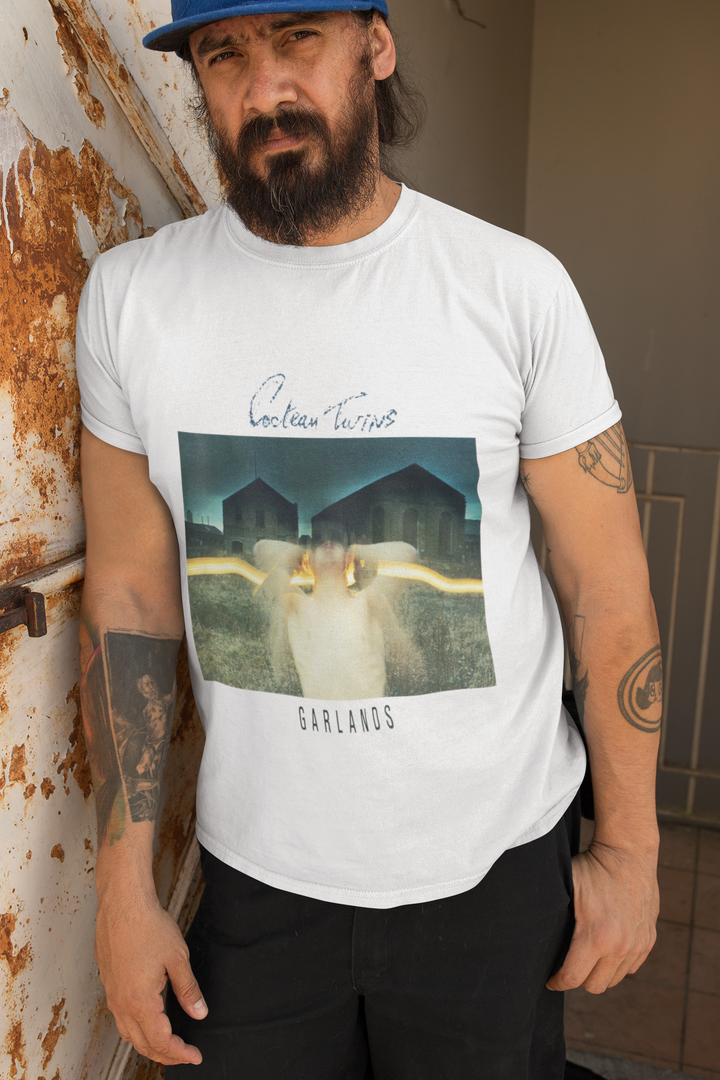 Cocteau Twins - Garlands T-Shirt 
Cocteau Twins were a Scottish post-punk/ethereal/dream pop band formed in 1981 in Grangemouth, Falkirk. Known for their unique sound and ethereal vocals, the band captivated audiences with their dreamlike melodies and atmospheric music. With a career spanning over 15 years, Cocteau Twins left an indelible mark on the music industry before disbanding in 1997. Their innovative approach to music continues to inspire artists today.