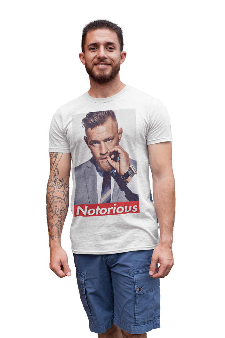 Show your support for Conor McGregor with this UFC T-shirt featuring The Notorious graphic. Perfect for fans of the UFC, this T-shirt is a must-have for any collection.