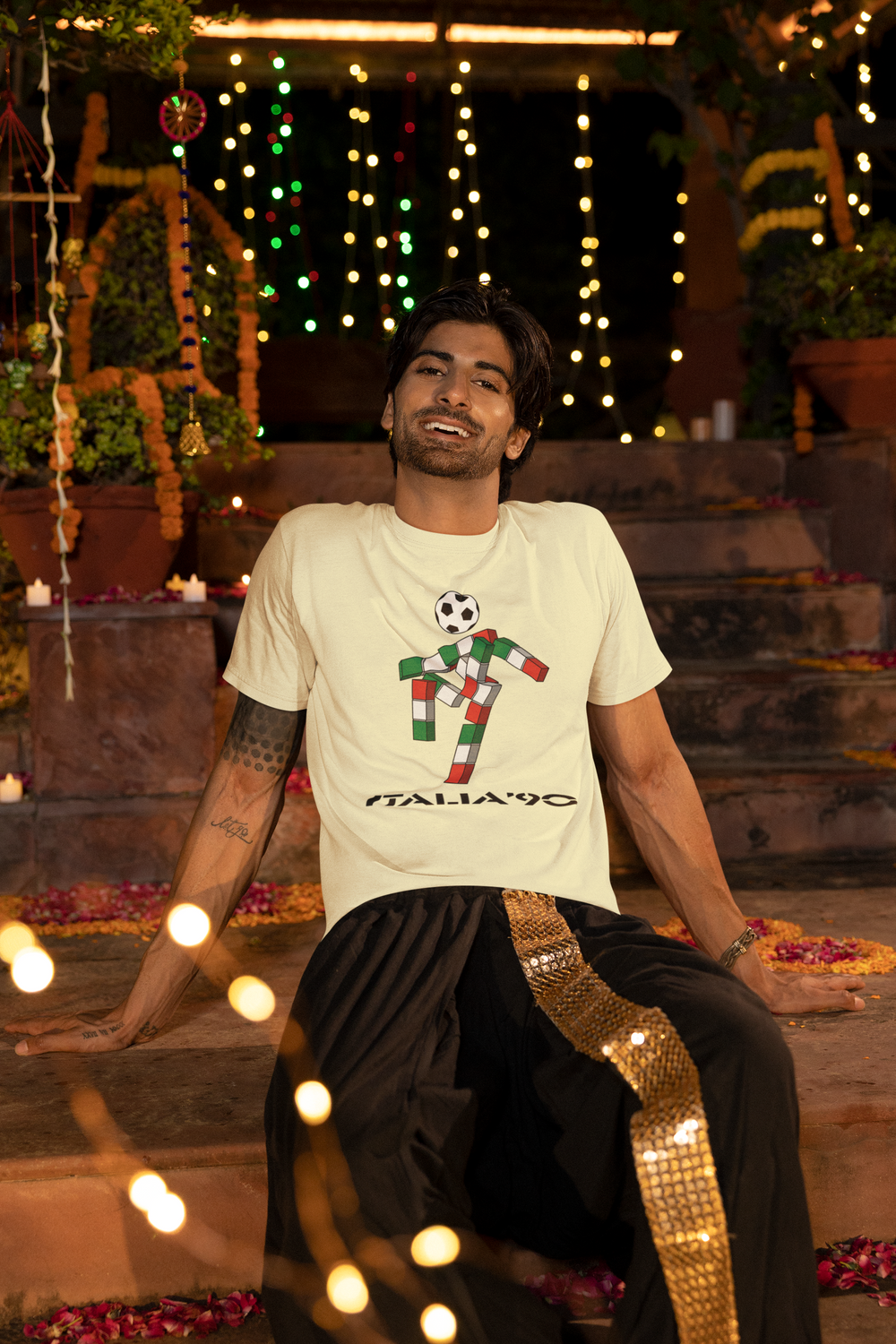 We love a retro t-shirt here and our ultra cool Italia 90 t-shirt is no exception. Ciao was the mascot for the 1990 FIFA World Cup in Italy: 
A gender-neutral, futuristic stick figure with a football head and an Italian tricolor body that spelled out "ITALIA" 
Designed by Lucio Boscardin, a self-taught graphic designer.