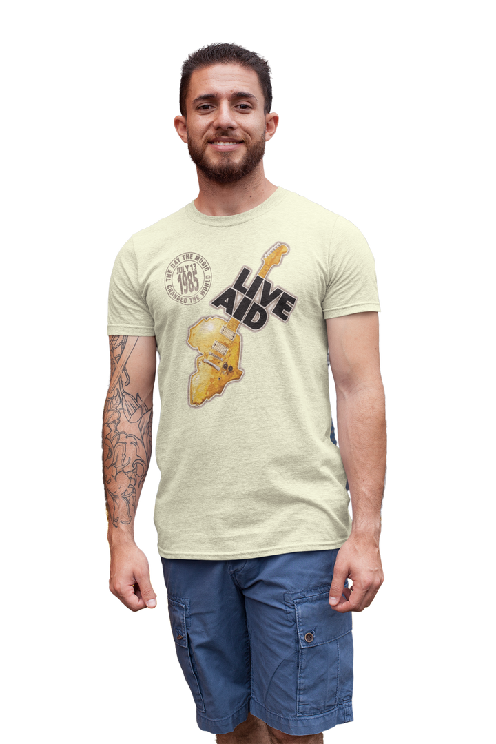 Live Aid was a benefit concert held at Wembly Stadium in London on July 13, 1985. The event grew from the Band Aid single "Do They Know It's Christmas?". That song featured many of the UK's top pop stars and was organized by Bob Geldof of Boomtown Rats and Midge Ure, then of Ultravox. Geldof wore a "Feed The World" T-shirt during the songs recording. All artists took the stage to further raise money for famine relief in Africa. *A portion of proceeds from this t-shirt sale benefits Oxfam.