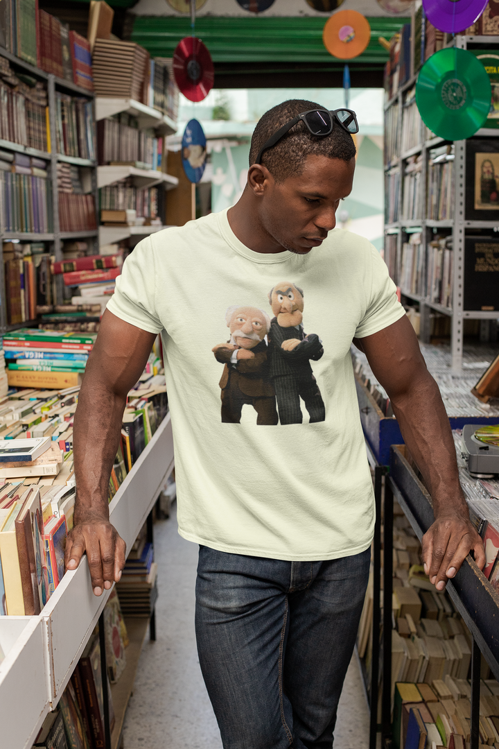 This Muppets t-shirt features an image of the balcony hecklers Statler and Waldorf. Statler and Waldorf are constantly criticizing all of the other Muppets, but find themselves extremely entertaining, and they will inevitably burst into laughter at their insults hurled from their balcony.
Statler and Waldorf are usually mean-spirited, but their insults have made them fan favorites. Show that you are a fan of the cranky Muppets with this T-Shirt!